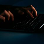person using black laptop computer